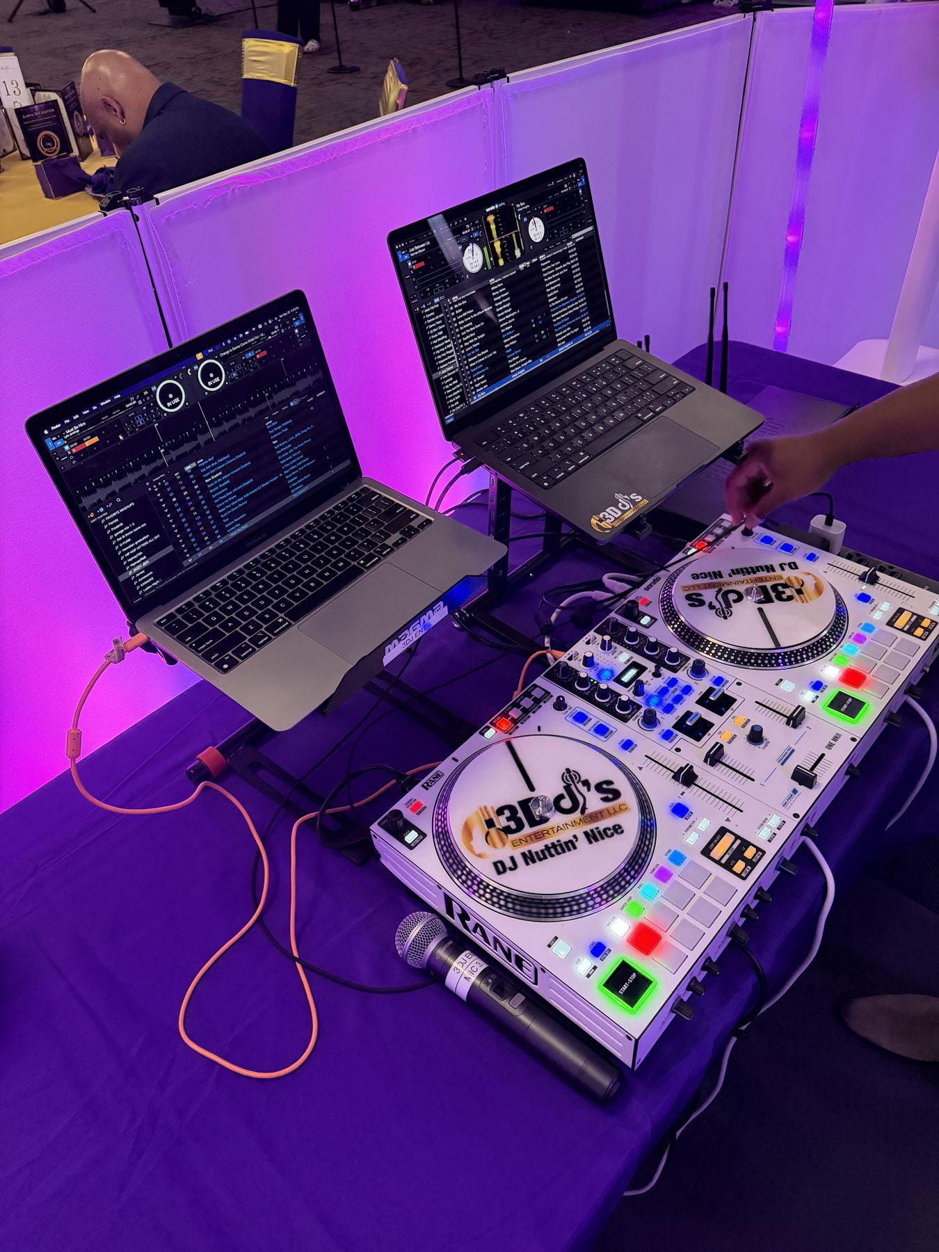 Rane controller with 3D DJ's platter labels, two laptops and a wireless mic