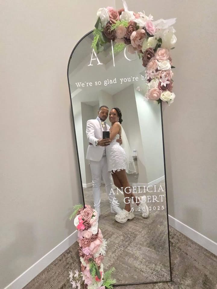 Couple at custom wedding mirror