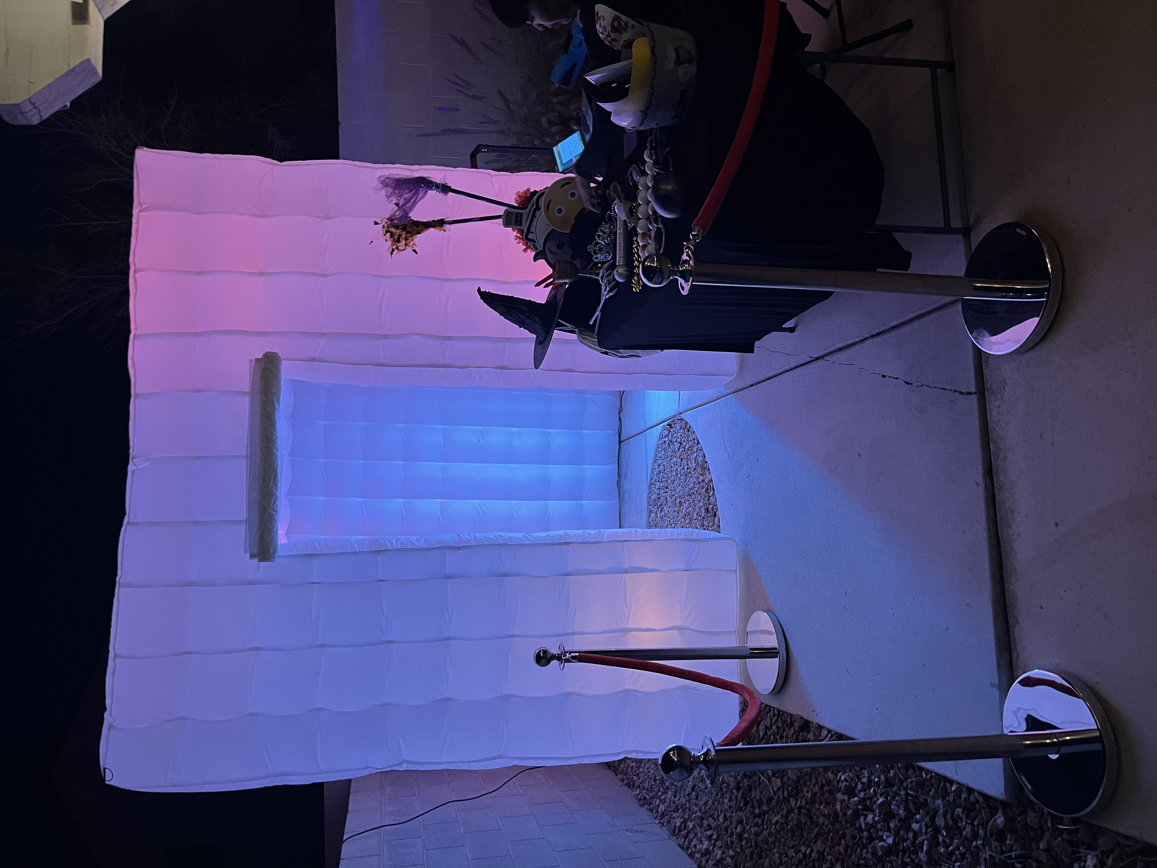 Inflatable photo booth with props and stanchions